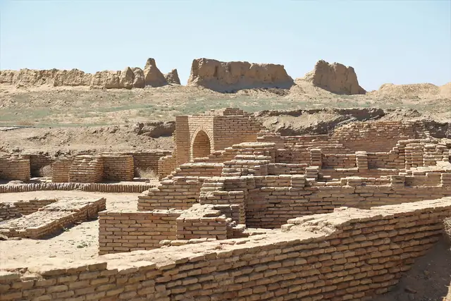 Turkestan: excavated brick ruins of medieval Sauran with crumbling city walls behind